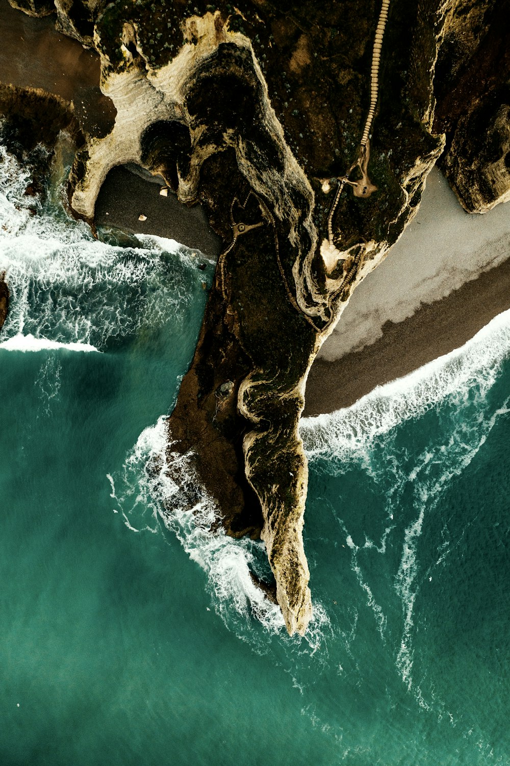 aerial photography of cliff viewing body of water during daytime