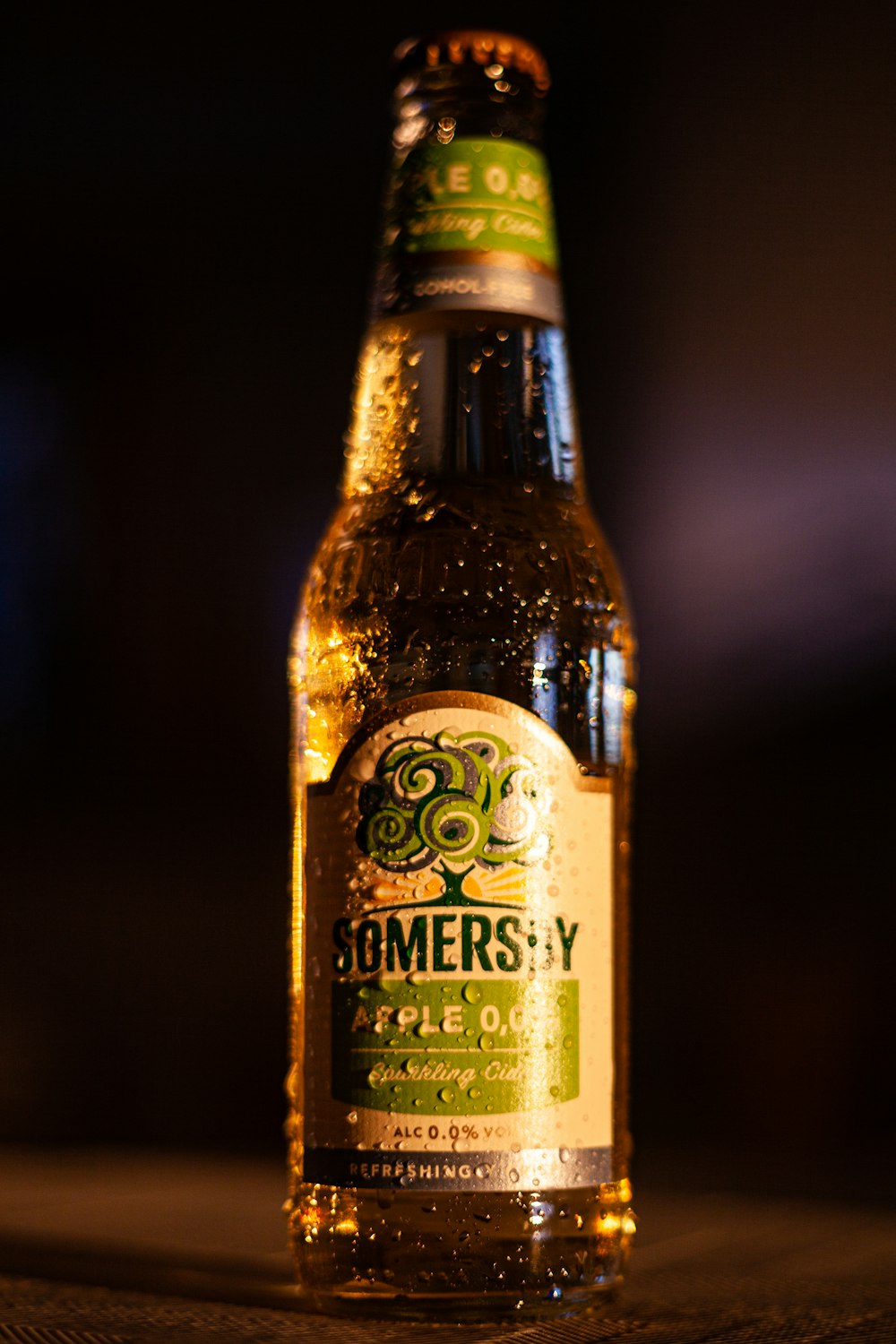 green and white-labeled apple-flavored beer bottle