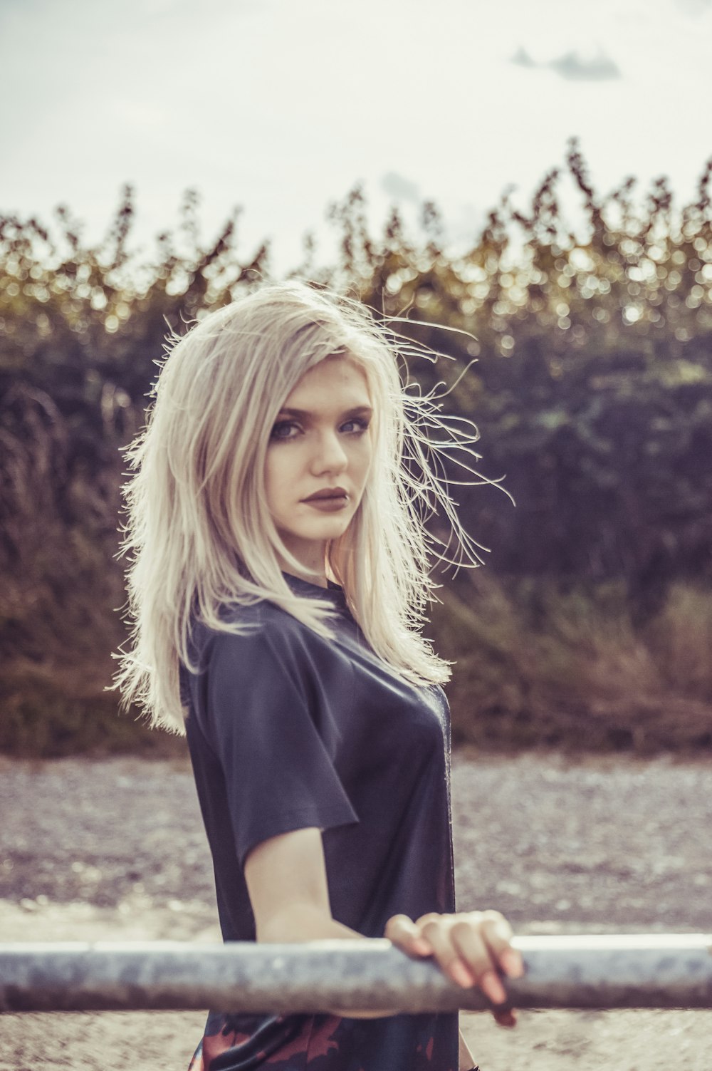 blonde-haired woman looking over her shoulder