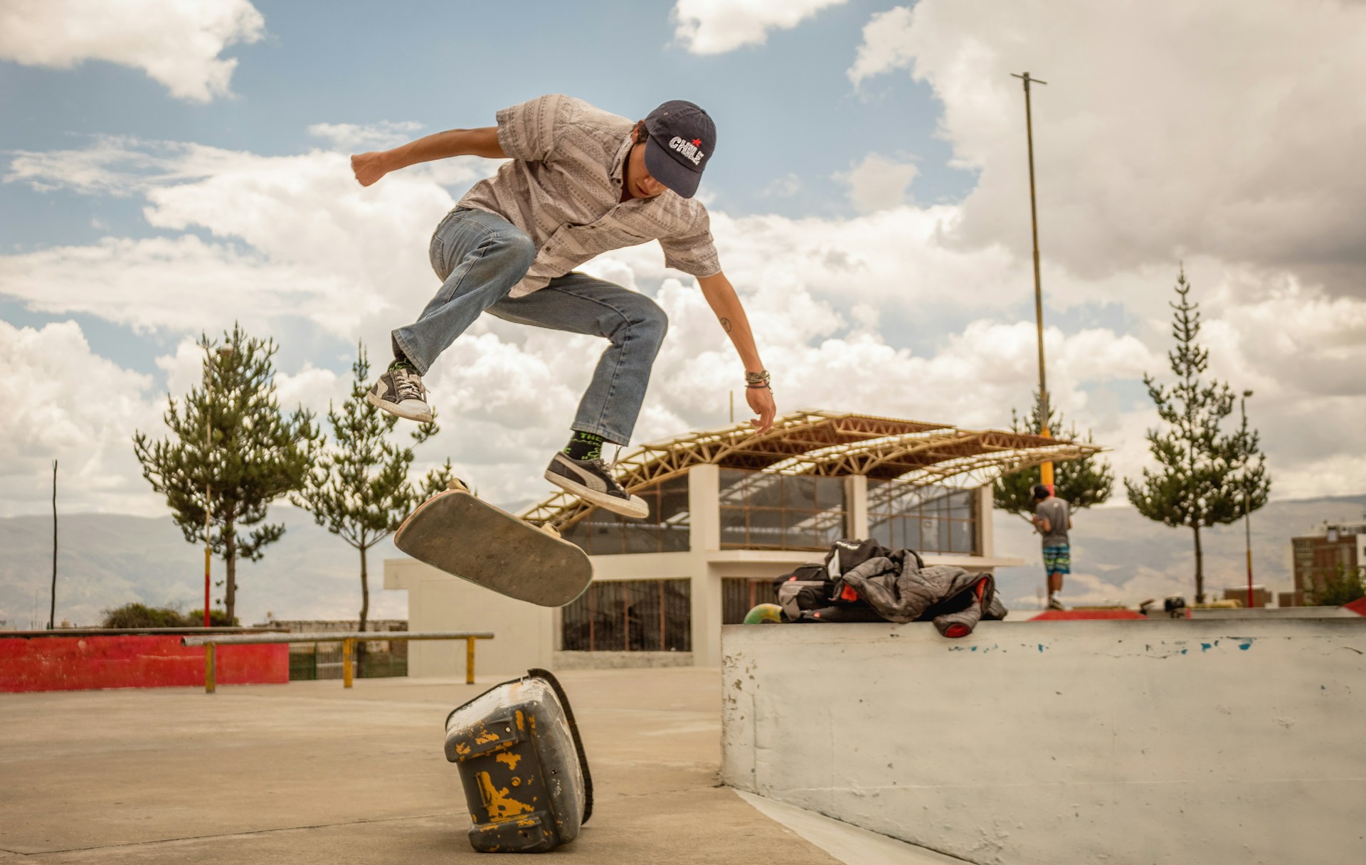 man riding skateboard in mid air above rock