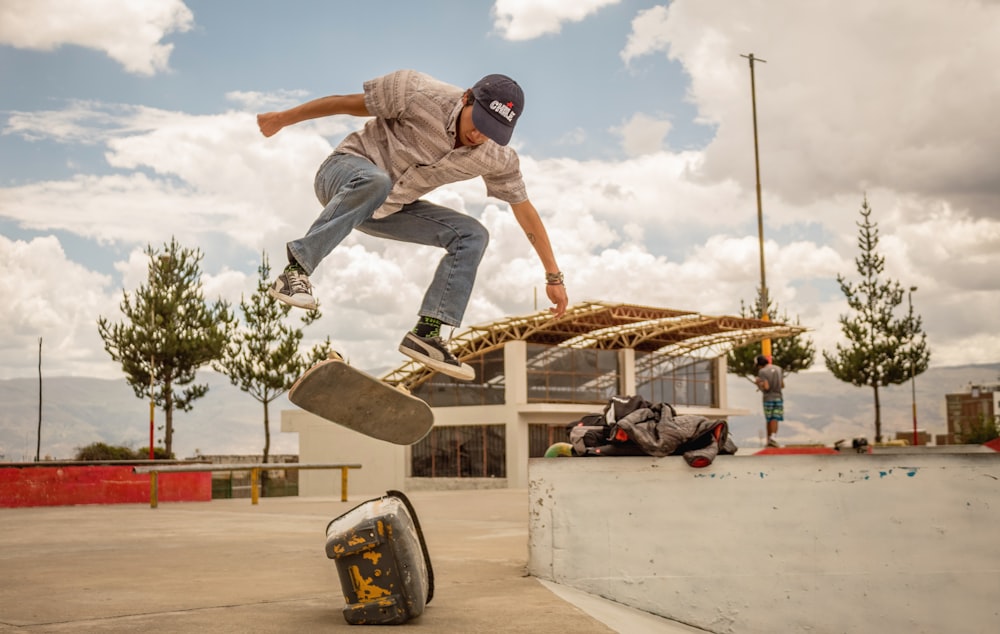 man riding skateboard in mid air above rock