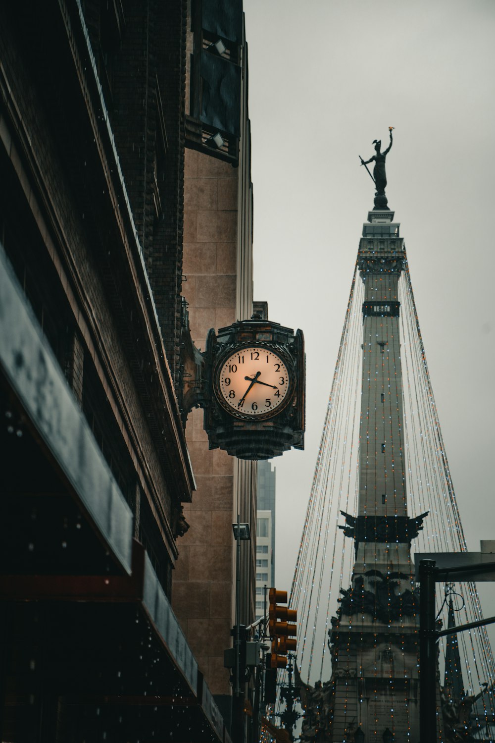 square black and white analog clock displaying 03:75 time outside building