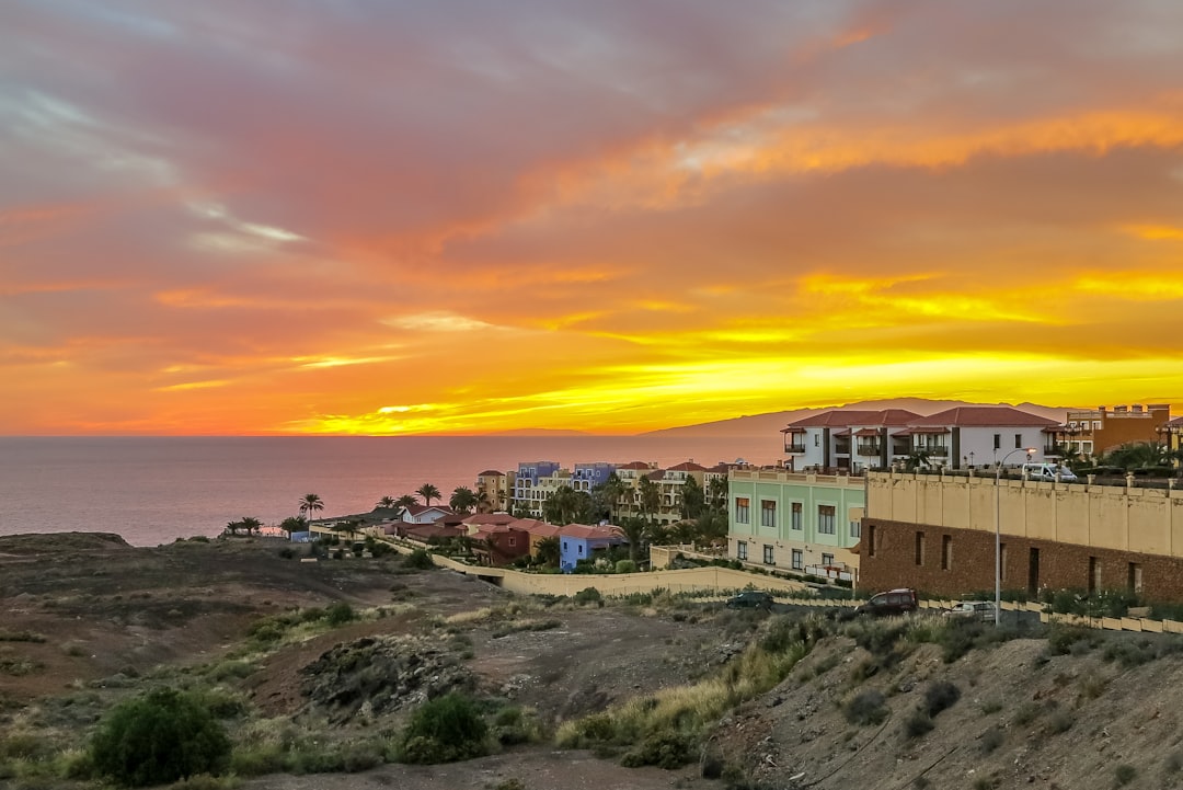 concrete buildings on rocky terrain during golden hour, Tenerife