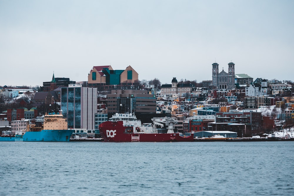 calm water by buildings under white sky