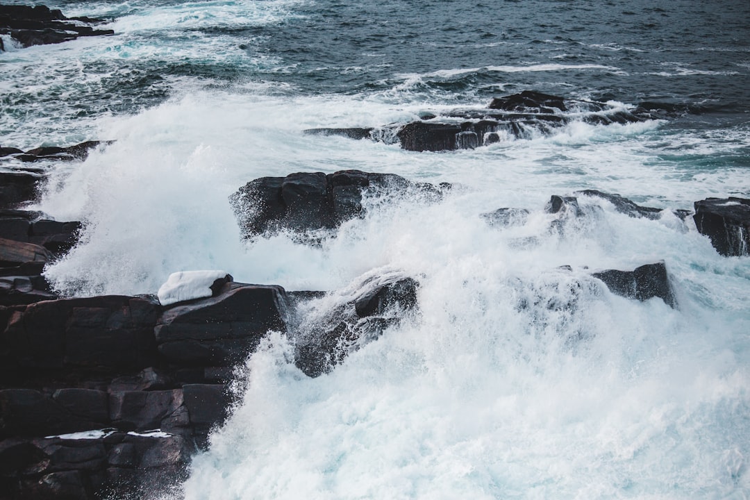 time-lapse photography of waves splashing on rocks