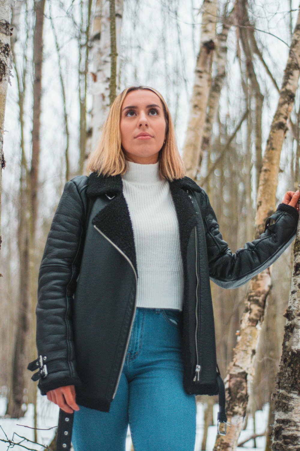 woman standing beside a tree