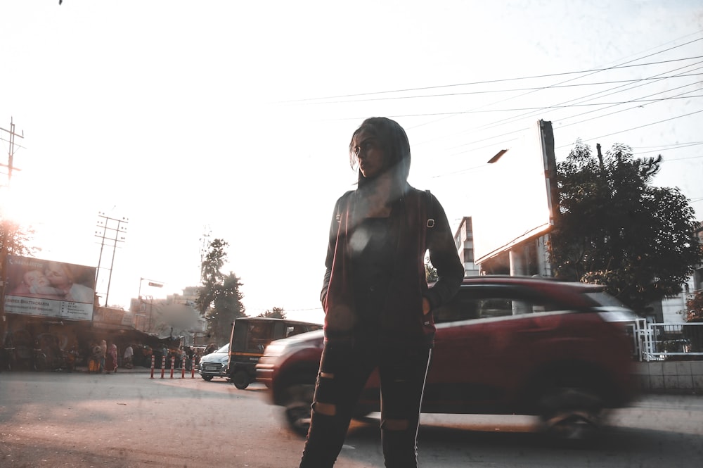 woman standing by vehicle at daytime