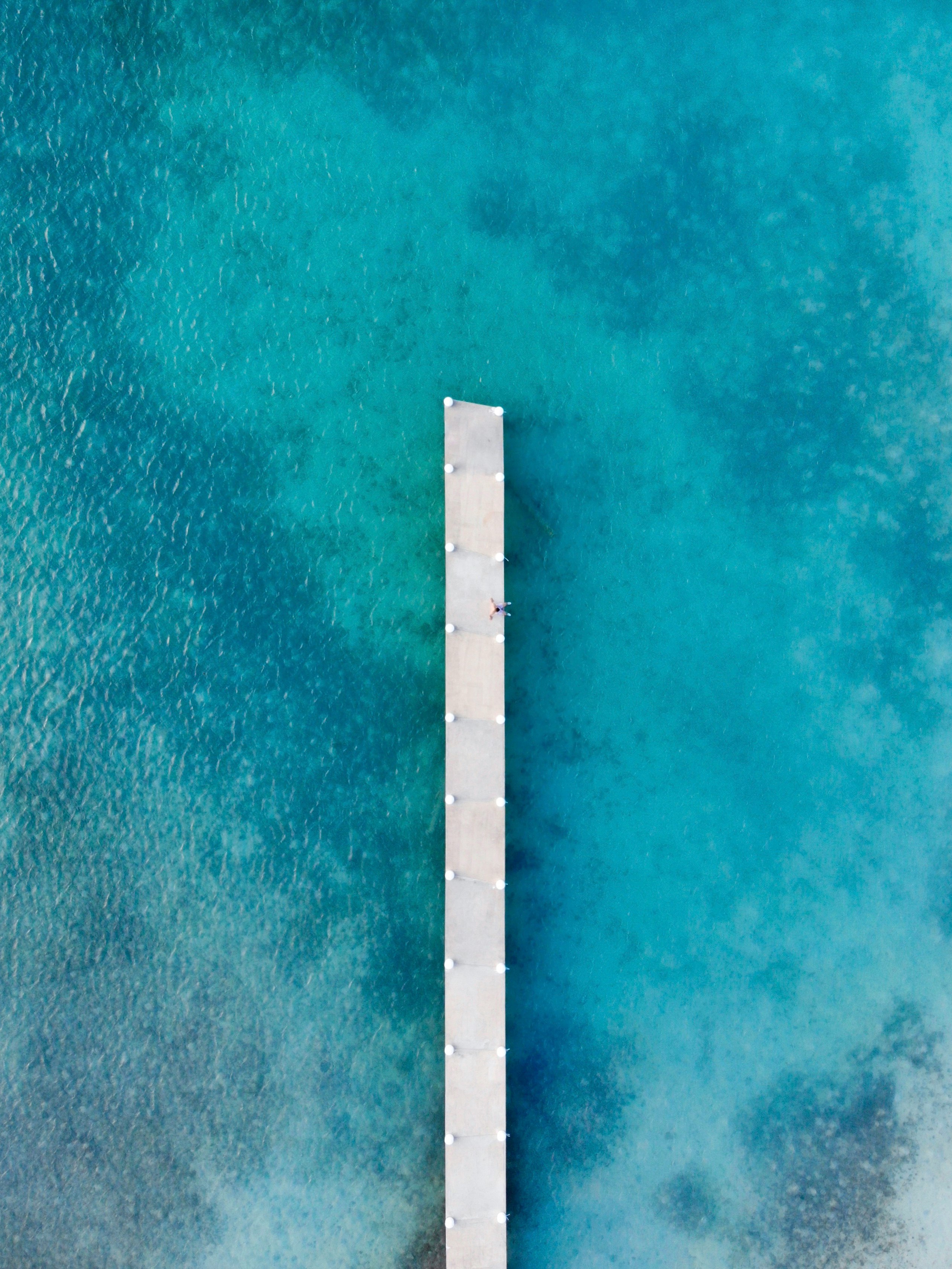 white wooden ocean dock