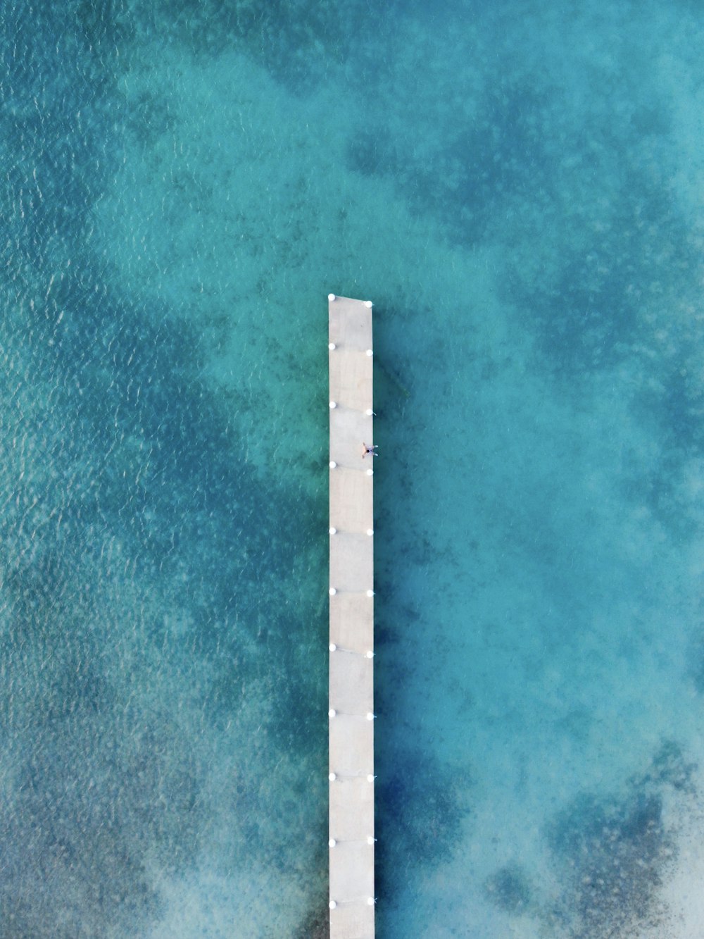 white wooden ocean dock