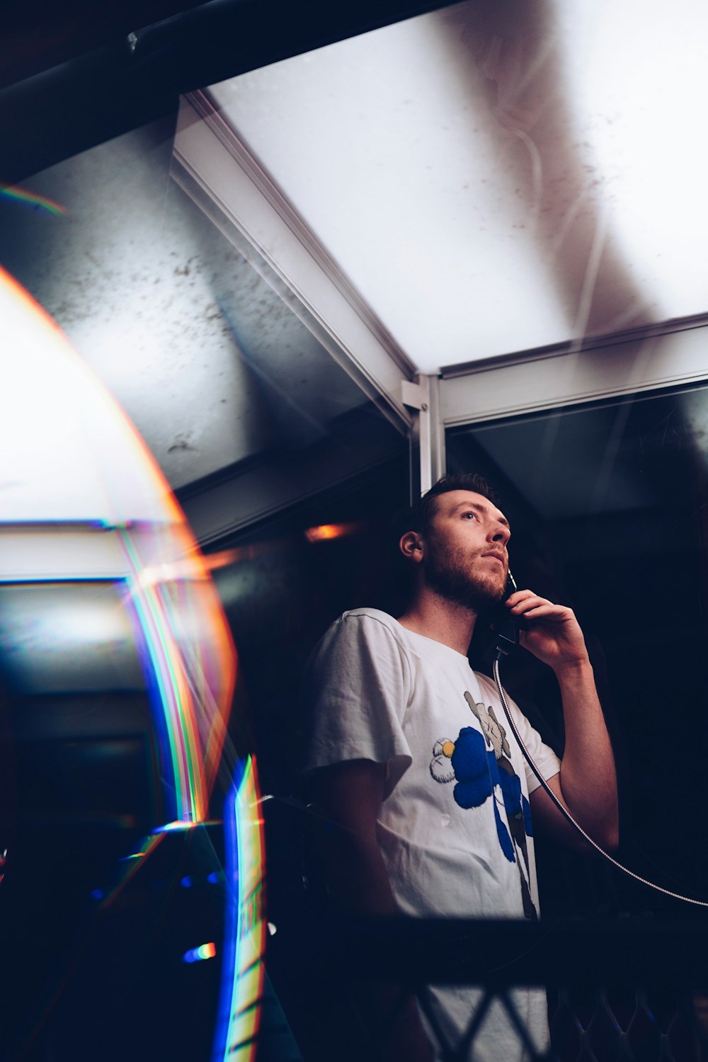 man in telephone booth at nighttime