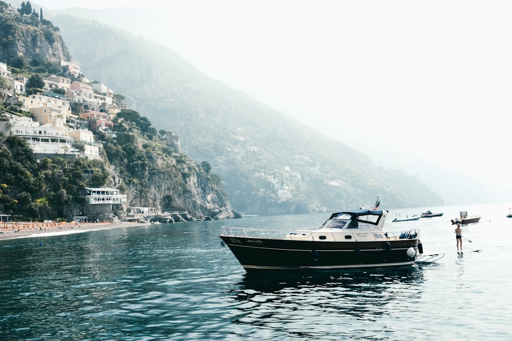 white and black motor boat on sea during daytime