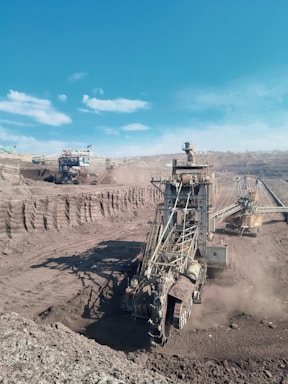 a large machine is in the middle of a dirt field