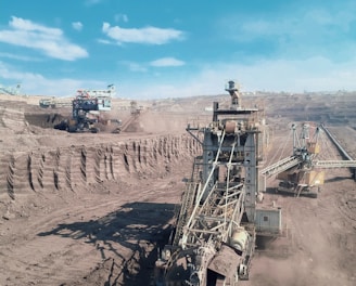 a large machine is in the middle of a dirt field