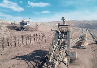 a large machine is in the middle of a dirt field