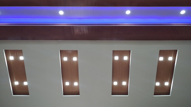 A skilled craftsman installing a stylish false ceiling in a modern living room.