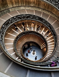 people walking on spiral staircase