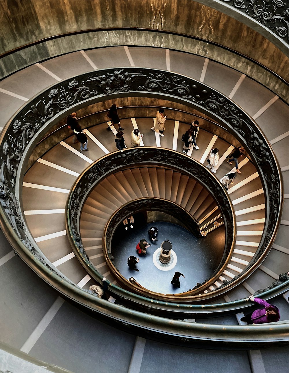 people walking on spiral staircase