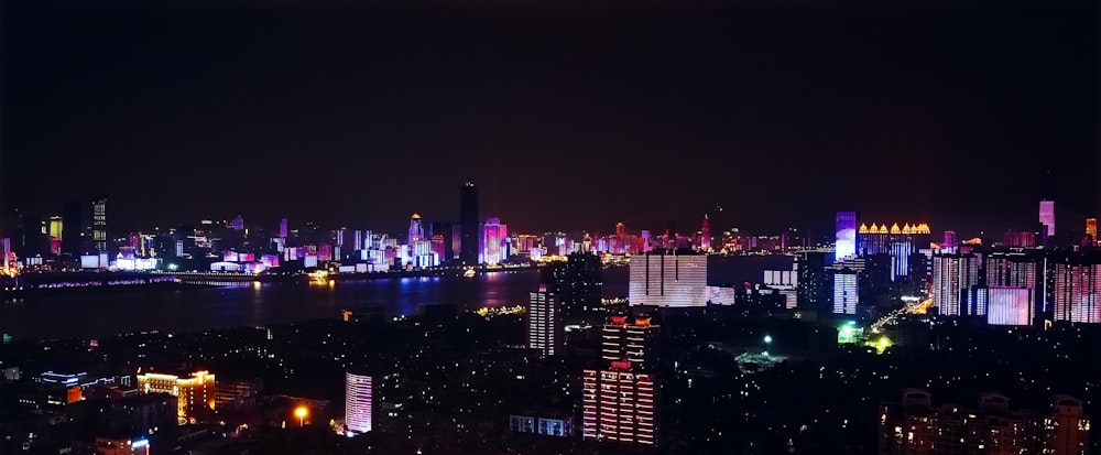 a view of a city at night from the top of a hill