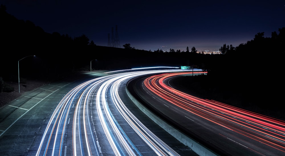 a long exposure photo of a highway at night