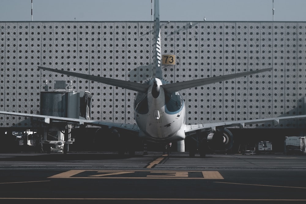 white and blue airliner parked on port