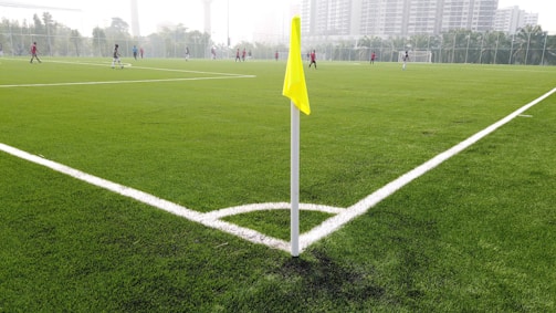 In-game action shot showing players battling near a flag on a custom-designed map.