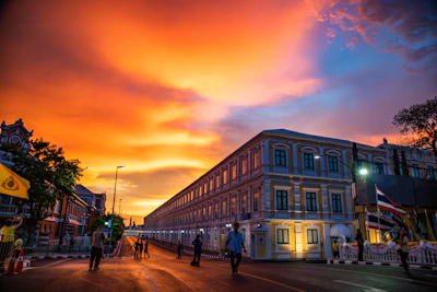 A vibrant image showing a group exploring the bustling streets of an imperial city at sunset.
