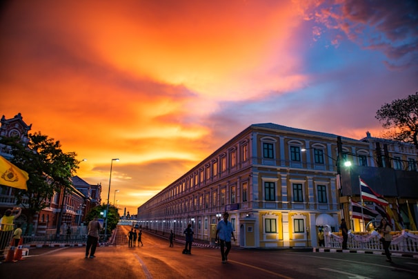 A vibrant photo of Independence Hall bathed in golden light during sunset.