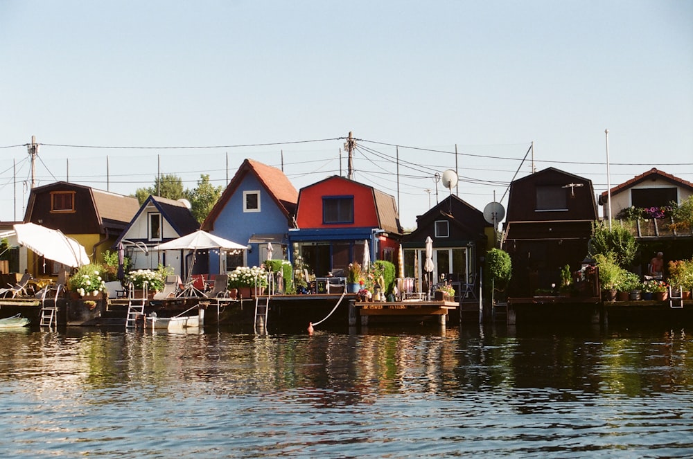 a row of houses sitting on top of a body of water