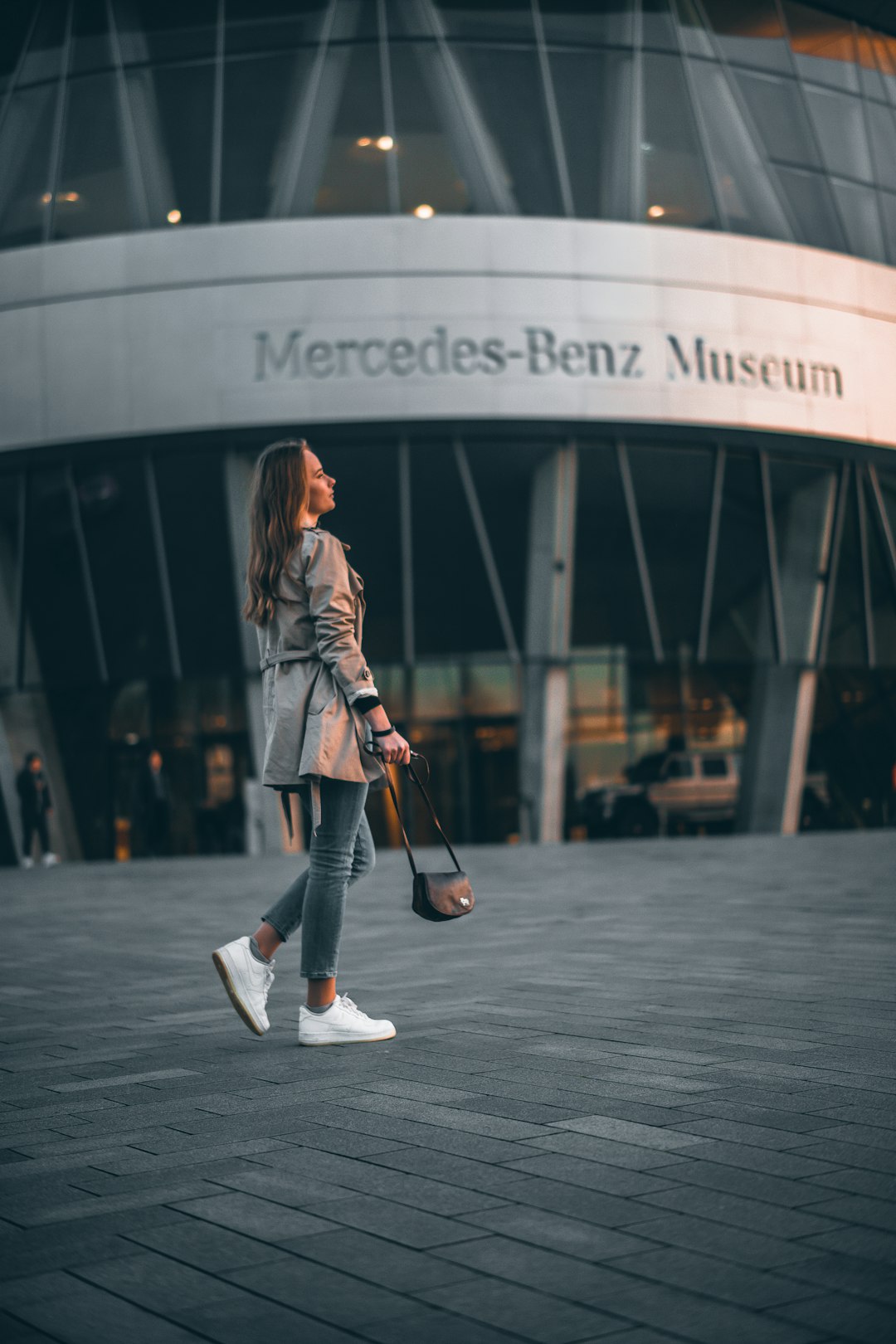 woman holding black leather bag