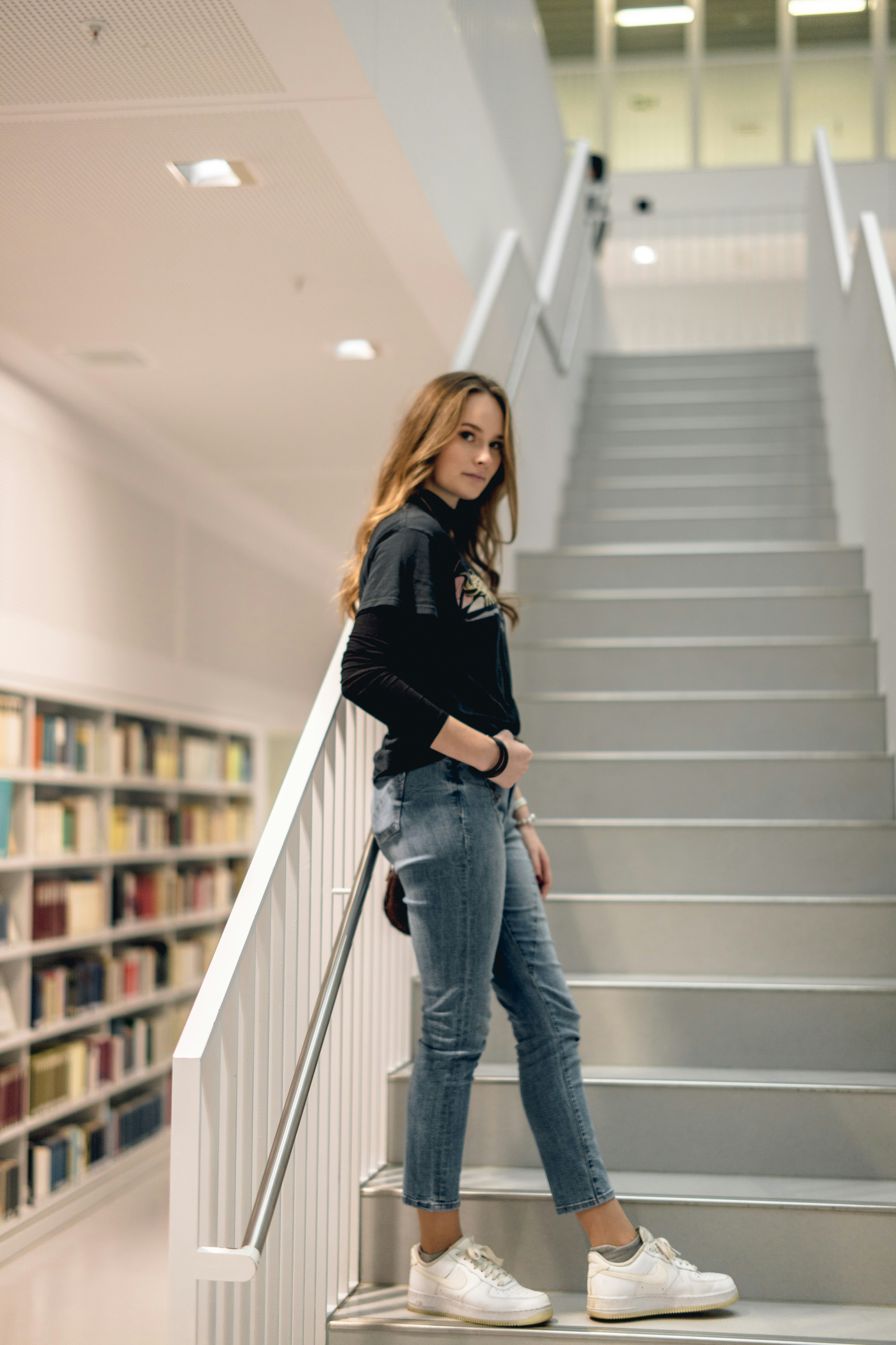 woman leaning on staircase