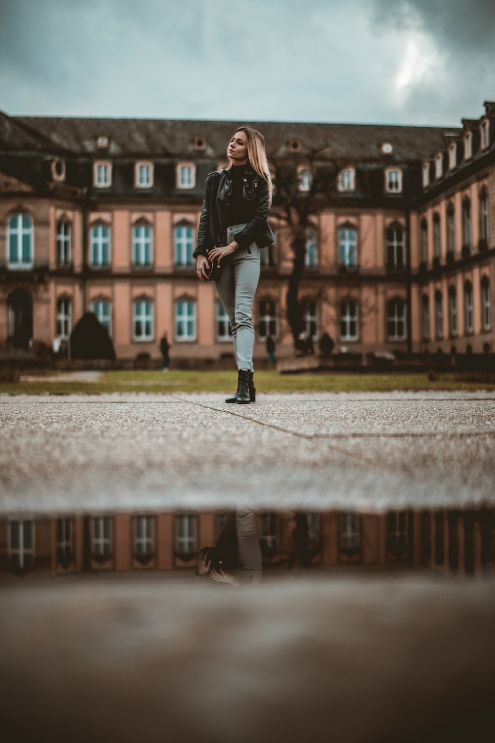 a woman standing in front of a large building