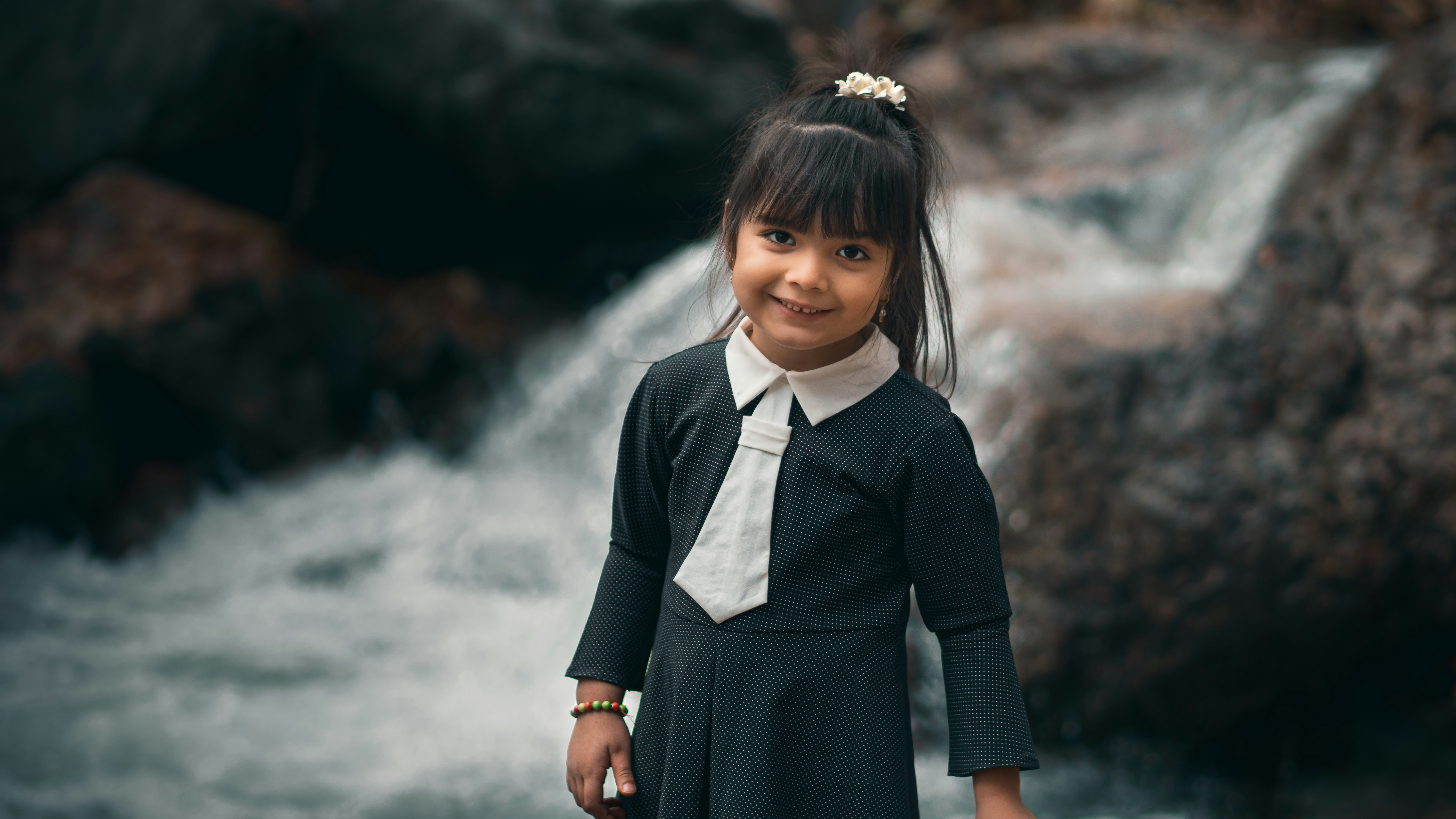 A young girl standing in front of a waterfall photo – Free Tehran Image ...
