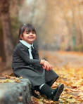 smiling girl sitting beside road