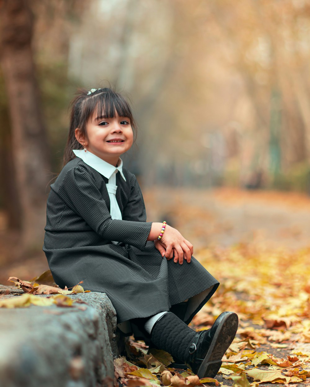 smiling girl sitting beside road