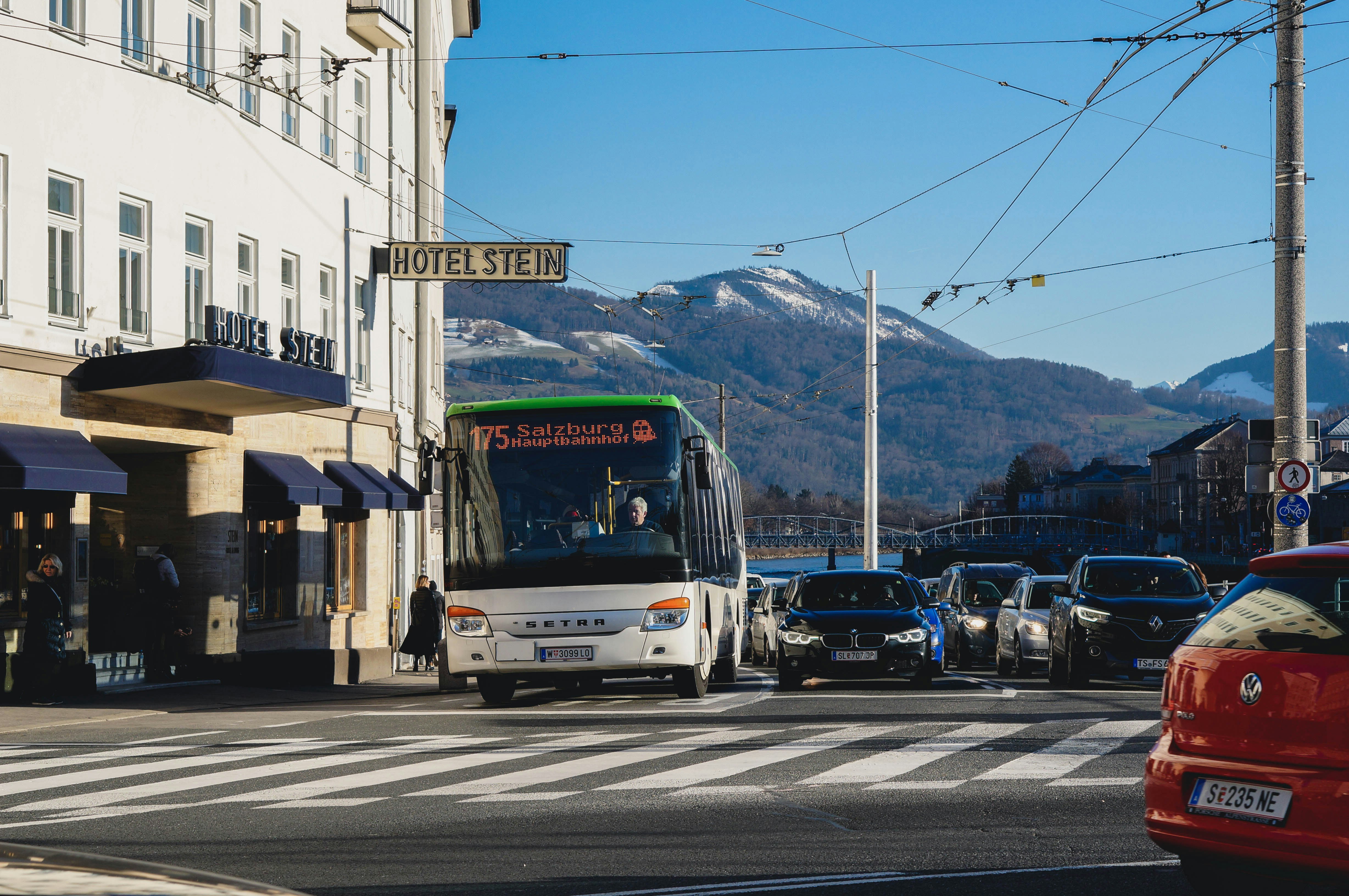 running bus beside black vehicle