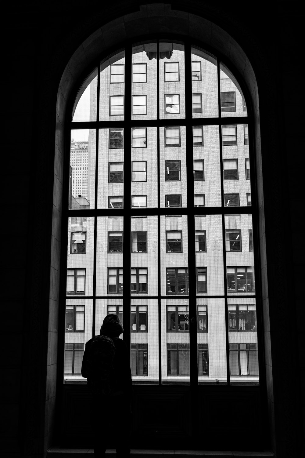 a person standing in front of a large window