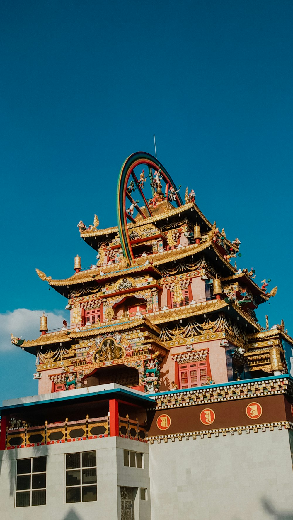 gold and red temple under blue sky