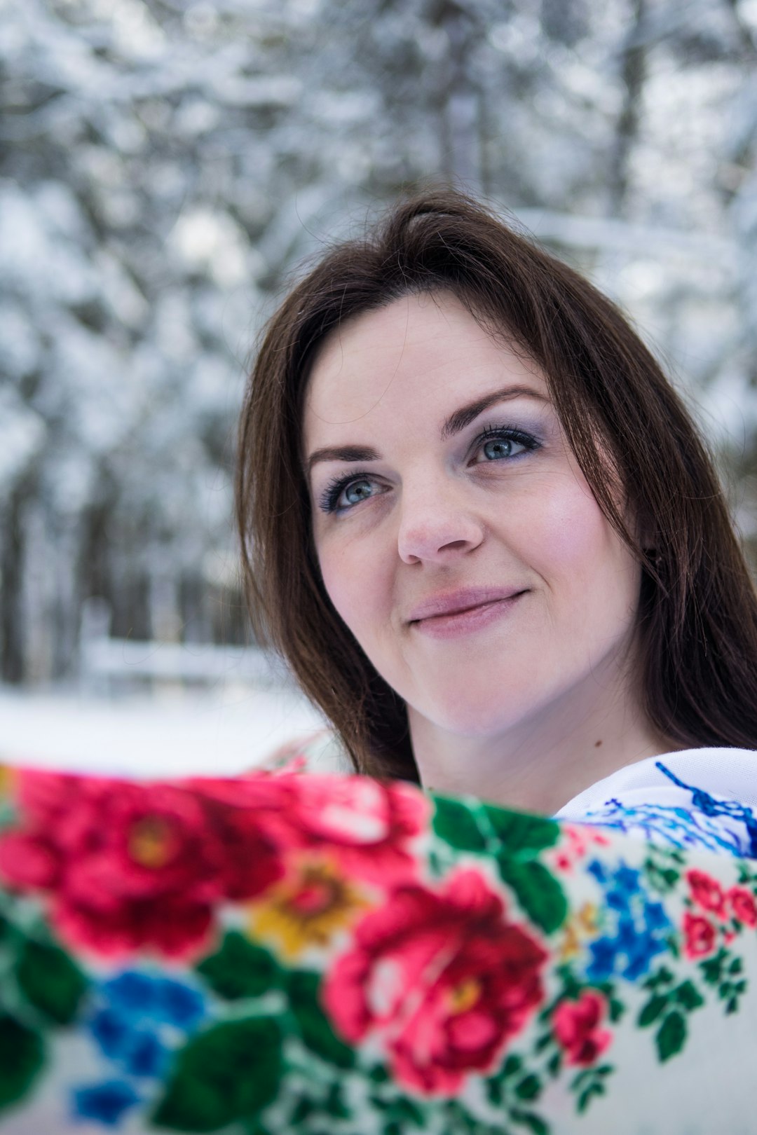 shallow focus photo of woman in white, blue, and red floral top