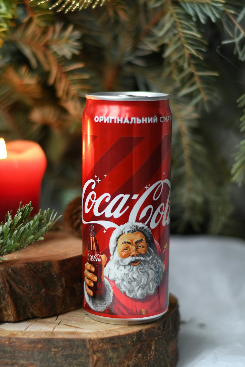 red Coca-Cola soda can on wood slice