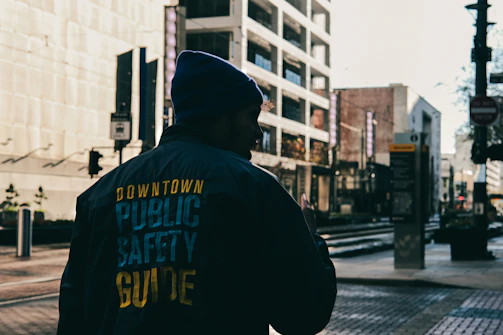 Discreet personal protection agent accompanying a client through a busy city street.