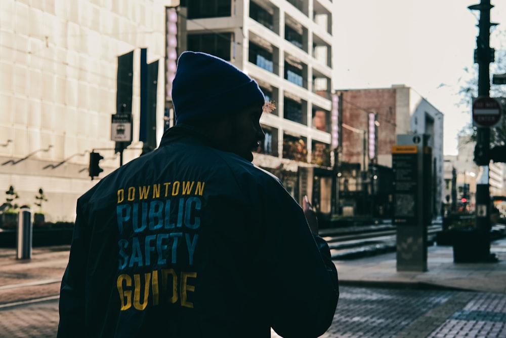 man walking on sidewalk during daytime