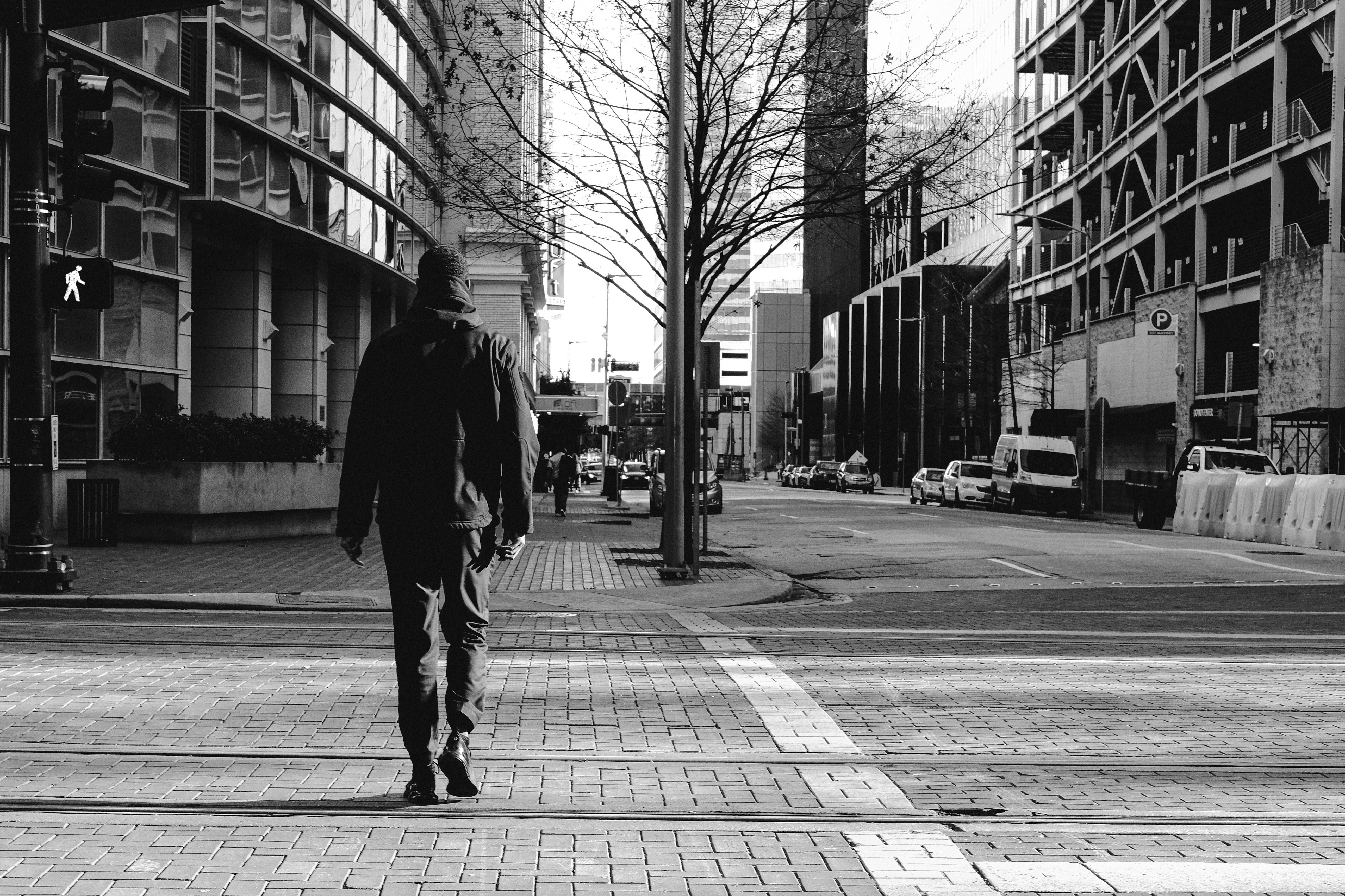 man walking on sidewalk during daytime