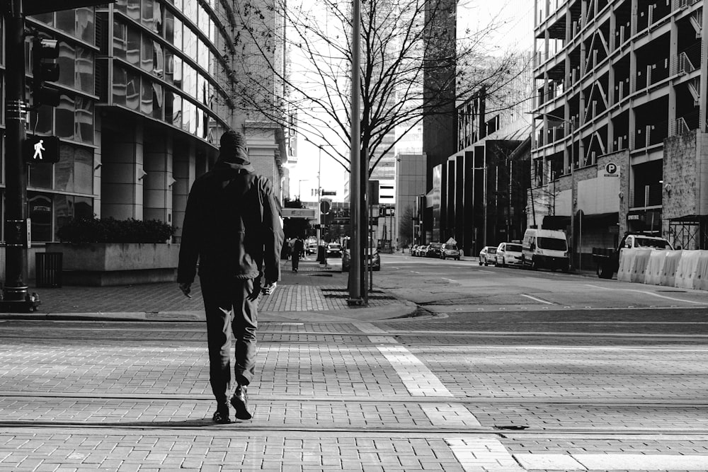 man walking on sidewalk during daytime