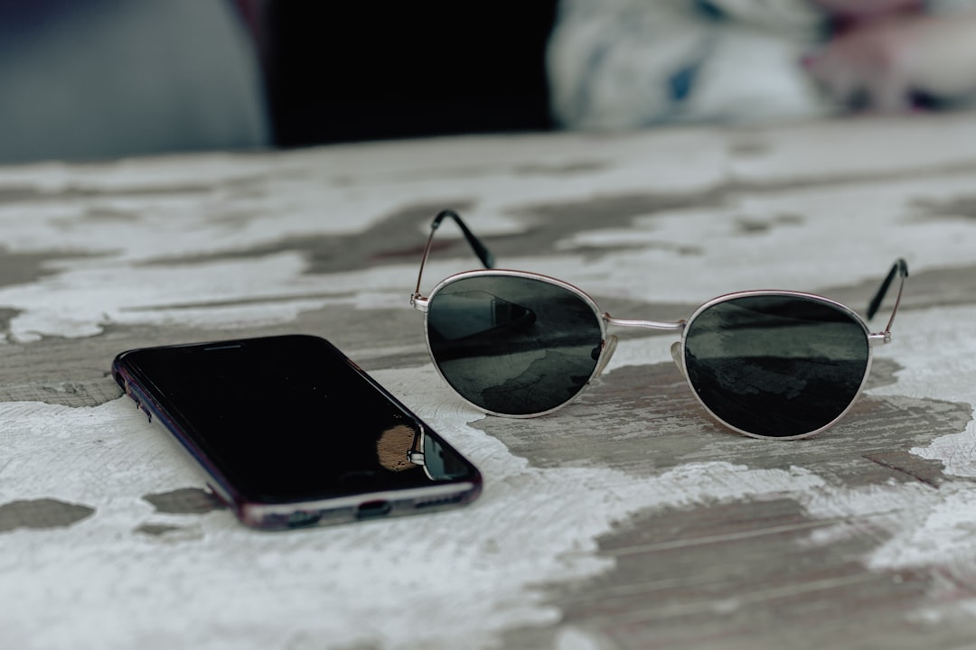 smartphone beside the sunglasses