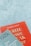 Two books are arranged on a surface, with one book titled 'WRITE Better, SPEAK Better' in red and the other titled 'How to Overcome Your Nervous Tension' by Alfred Tack in a muted green color.