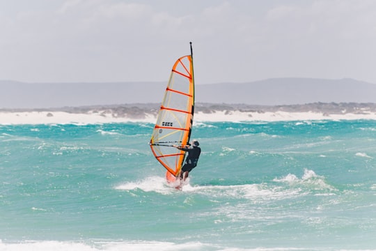 man riding on the boat photograph in Struisbaai South Africa