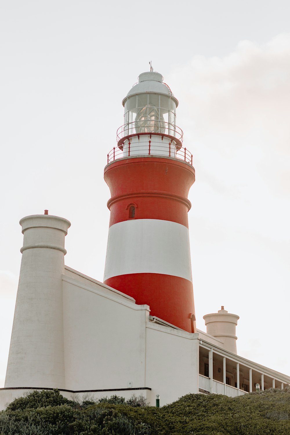 white and red lighthouse under white sky