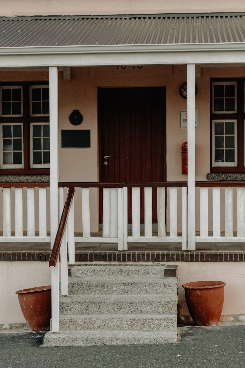 casa de madeira branca com porta de madeira marrom fechada