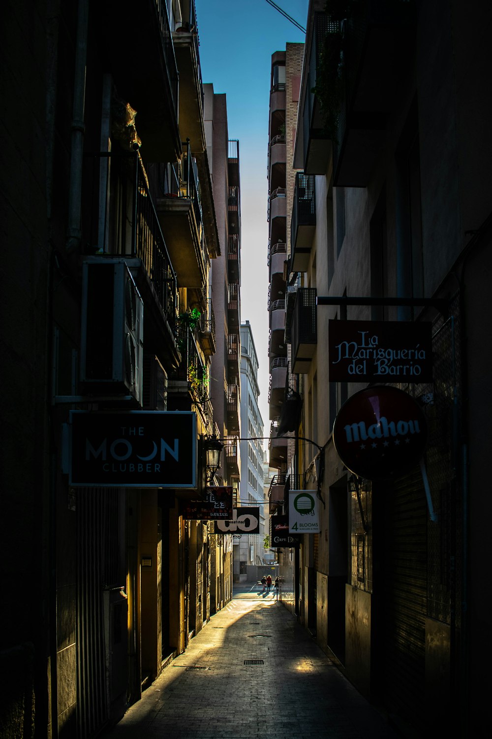 a narrow city street lined with tall buildings