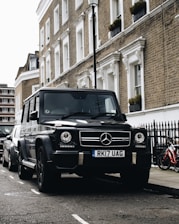 black Mercedes-Benz SUV parked beside road